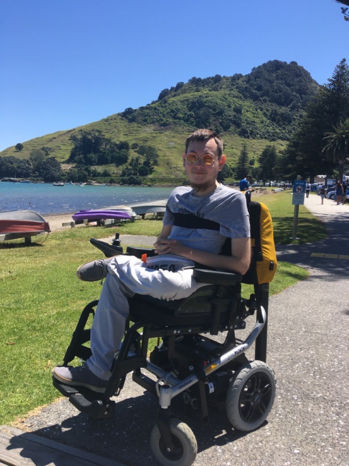 A white man in a wheelchair at a beach